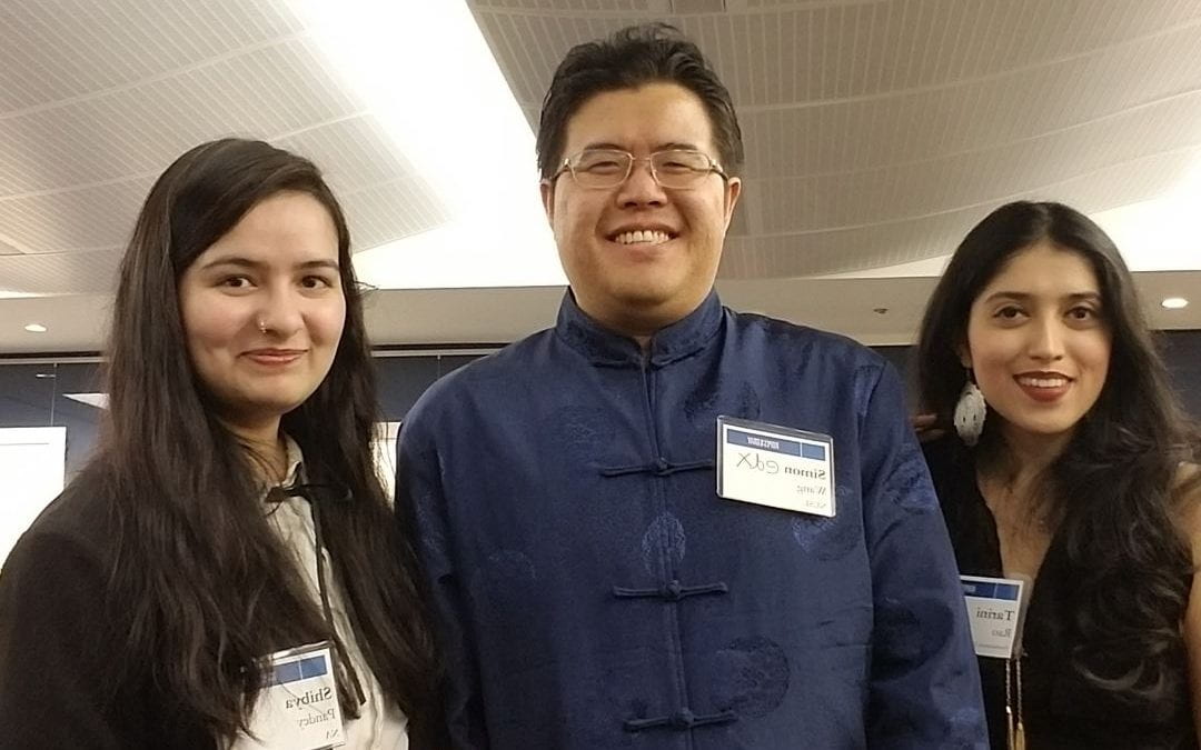 Three LLM students pose together at the event